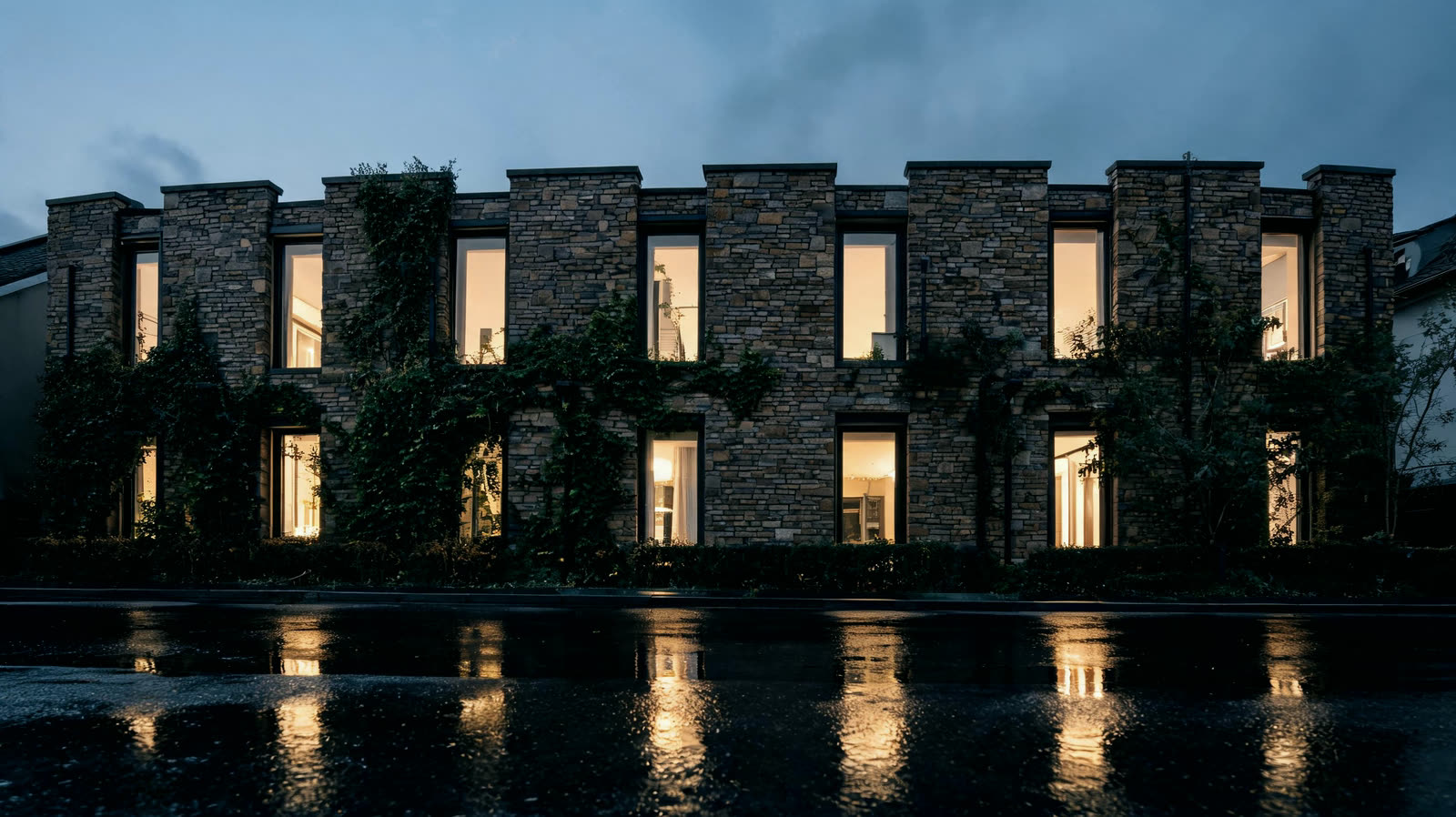 The lit facade of a quiet townhouse office at dusk